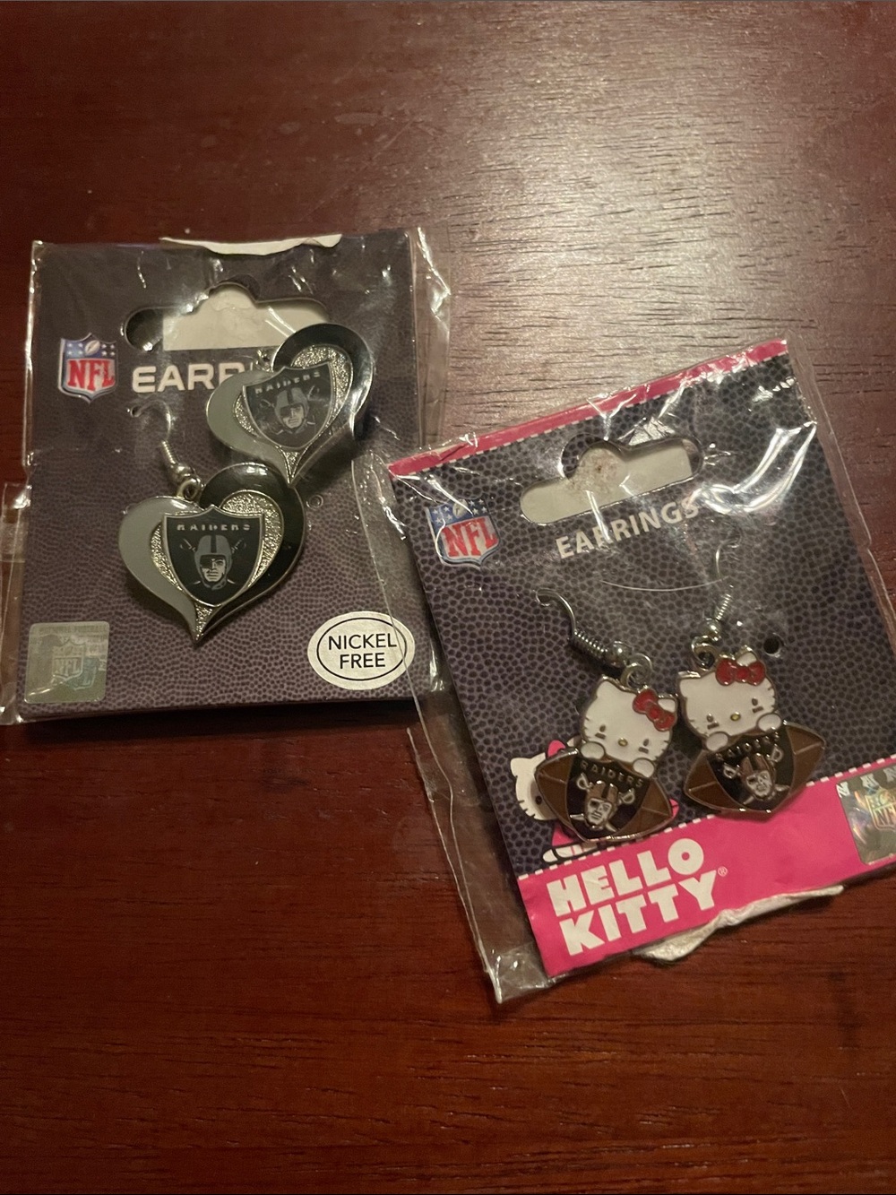 New in Package 2 RaiderSilver & Black Heart & Hello Kitty both dangle earrings